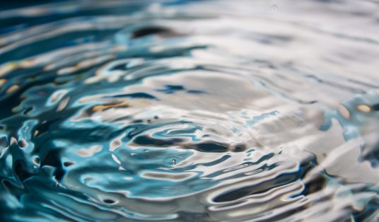 Water splash or drop. Water splash close-up. Blue water drop. Falling water