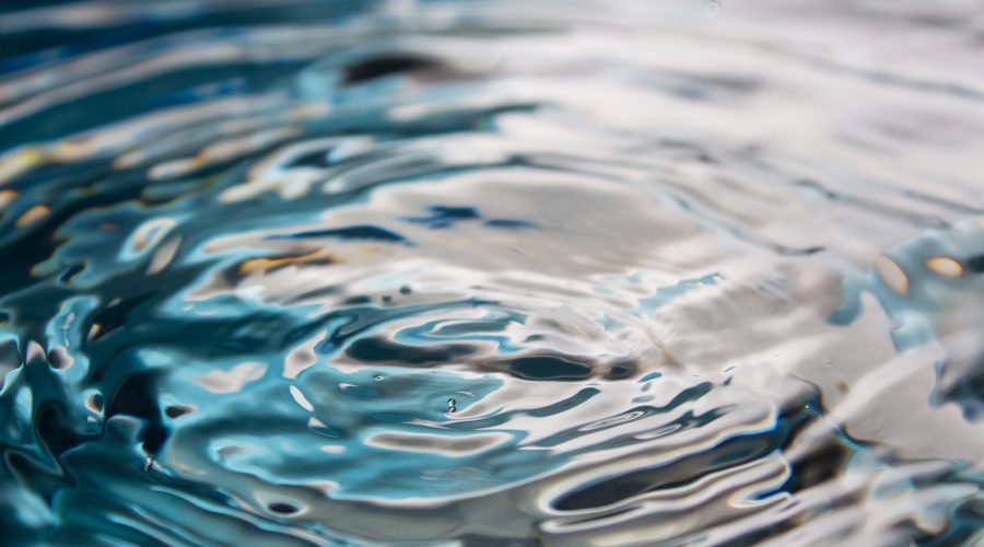 Water splash or drop. Water splash close-up. Blue water drop. Falling water